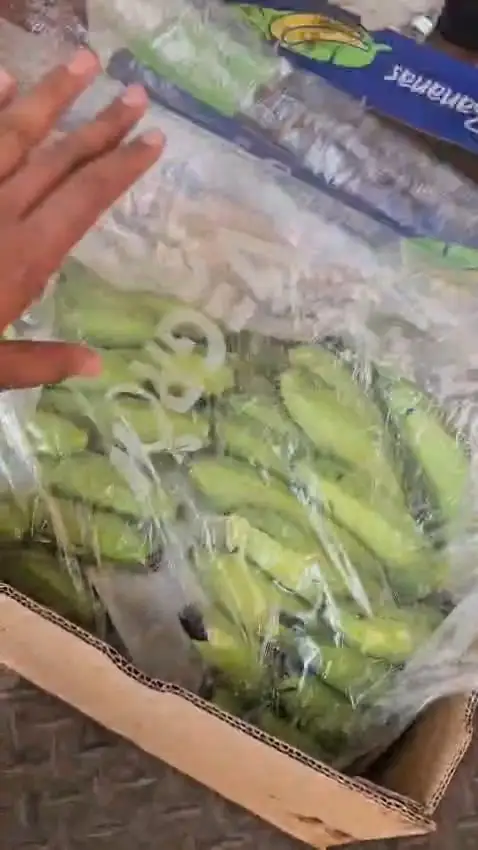 A banana drawn out of its bag for a closer look