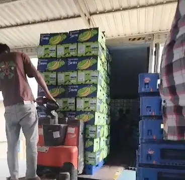 Cartons wheeled toward the open container